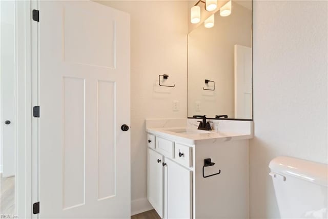 bathroom featuring toilet and vanity