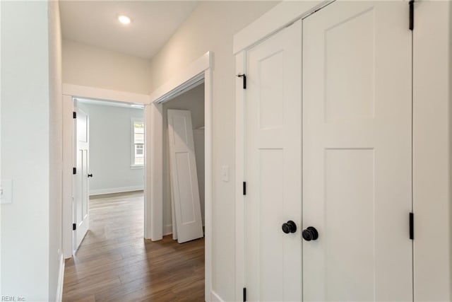 corridor with hardwood / wood-style floors