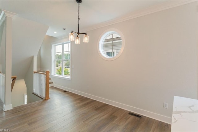 unfurnished dining area featuring wood-type flooring and ornamental molding