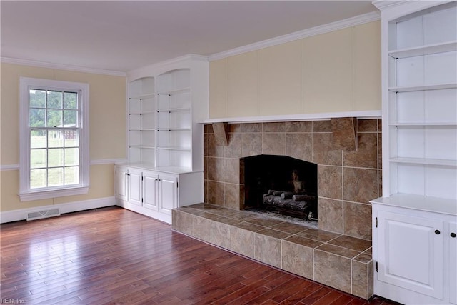 details featuring a tile fireplace, hardwood / wood-style floors, and ornamental molding