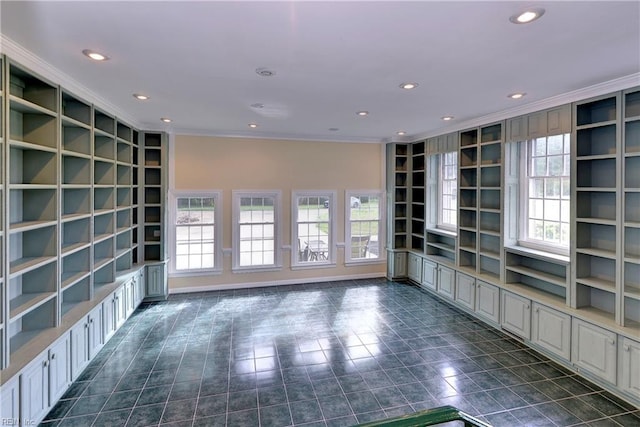 unfurnished living room featuring built in features and ornamental molding