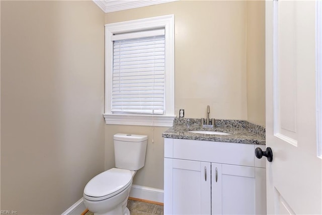 bathroom with crown molding, vanity, and toilet