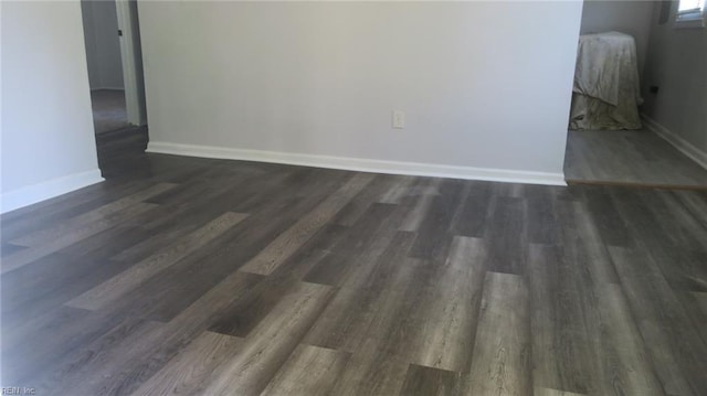 spare room with dark hardwood / wood-style floors