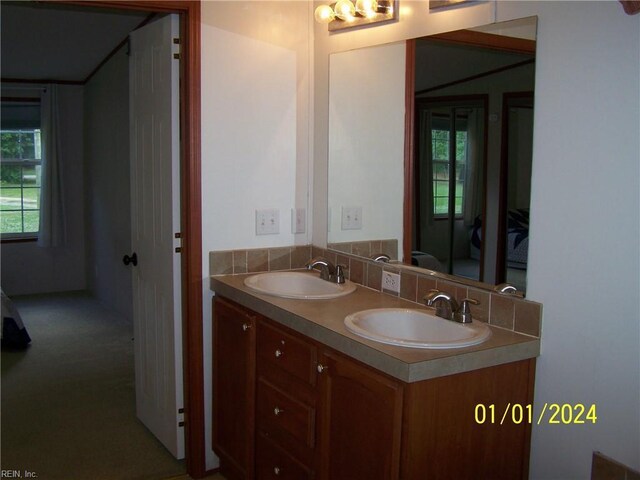 34026 Doctors Rd, Newsoms, VA 23874 - full bathroom featuring a sink, double vanity, and ensuite bath