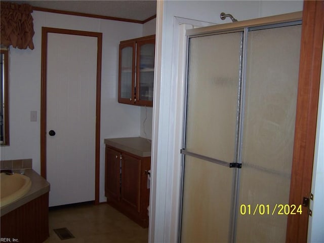 34026 Doctors Rd, Newsoms, VA 23874 - bathroom with vanity, visible vents, a stall shower, and ornamental molding