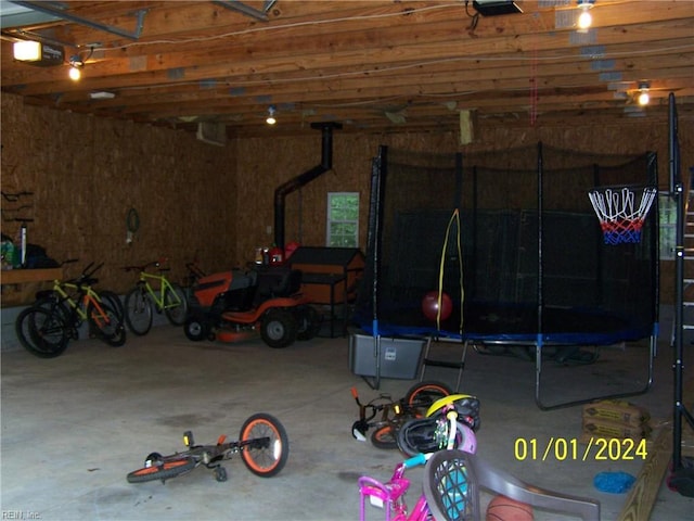 34026 Doctors Rd, Newsoms, VA 23874 - garage with a trampoline and a garage door opener