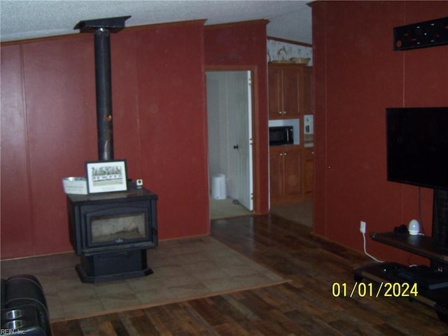 34026 Doctors Rd, Newsoms, VA 23874 - unfurnished living room with a wood stove and wood finished floors