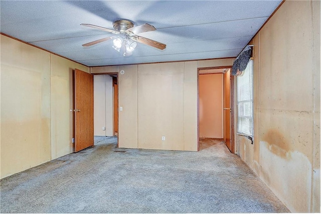 spare room featuring light colored carpet and ceiling fan