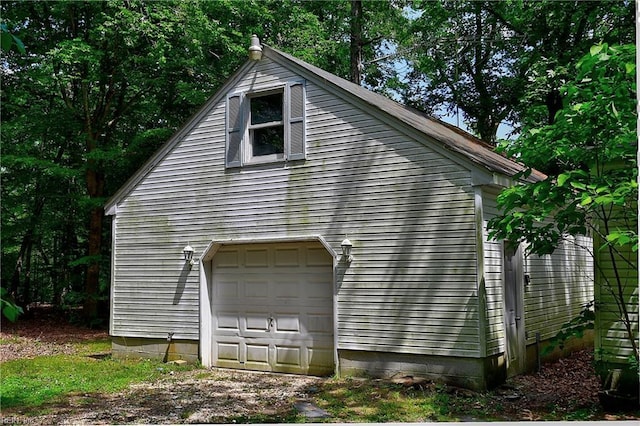 view of property exterior featuring a detached garage