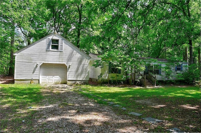 exterior space with a yard, driveway, and a garage