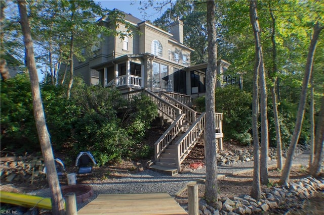 rear view of property with a sunroom