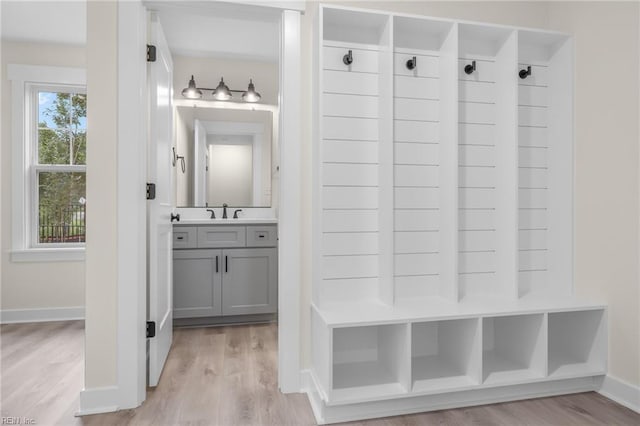 mudroom featuring sink and light hardwood / wood-style flooring