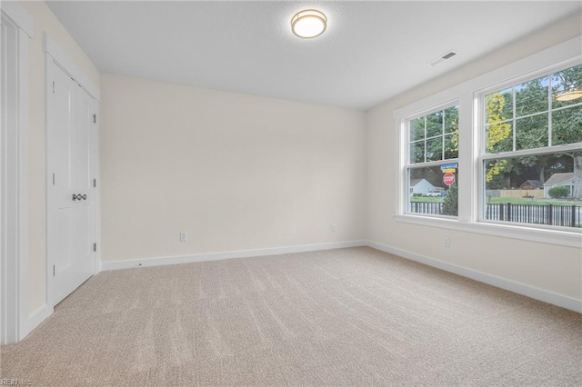 unfurnished room with light colored carpet