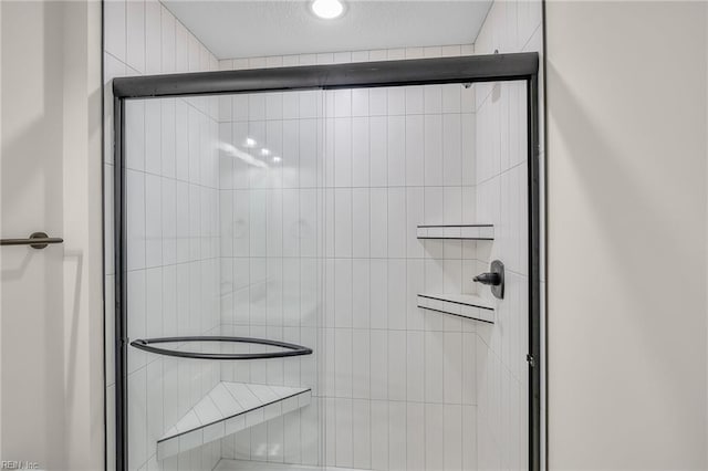 bathroom with a shower with door