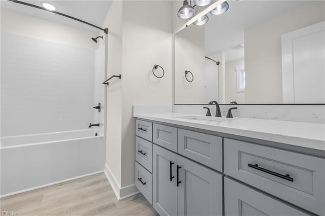 bathroom featuring vanity, bathing tub / shower combination, and hardwood / wood-style floors