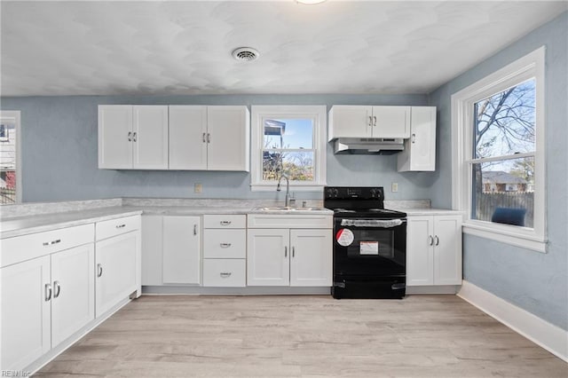 kitchen with white cabinetry, black electric range oven, light hardwood / wood-style flooring, and sink