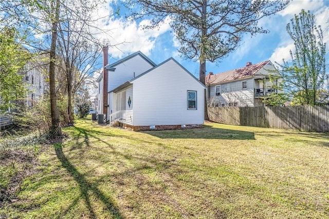 back of property featuring a yard and central AC unit