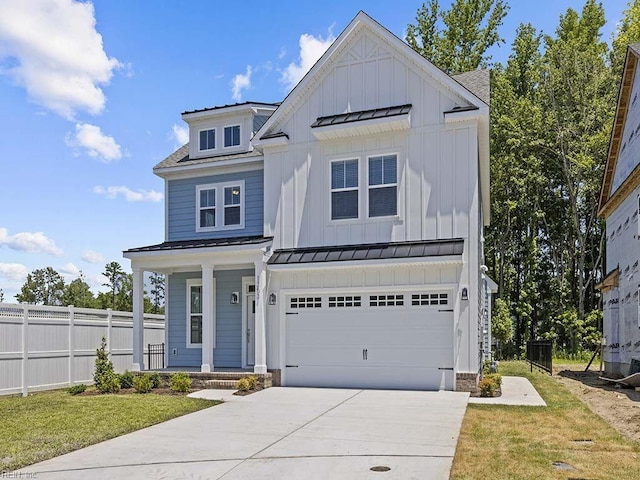 view of front of property featuring a front yard and a garage