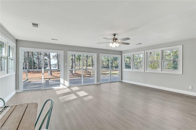 interior space with ceiling fan