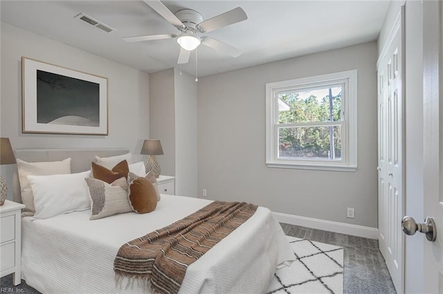 carpeted bedroom with ceiling fan and a closet