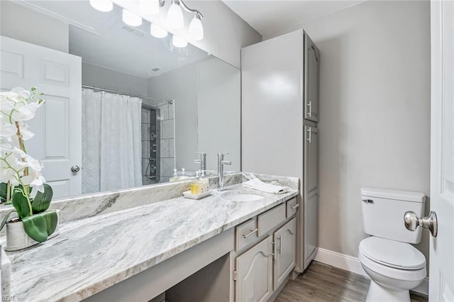 bathroom with wood-type flooring, vanity, toilet, and curtained shower