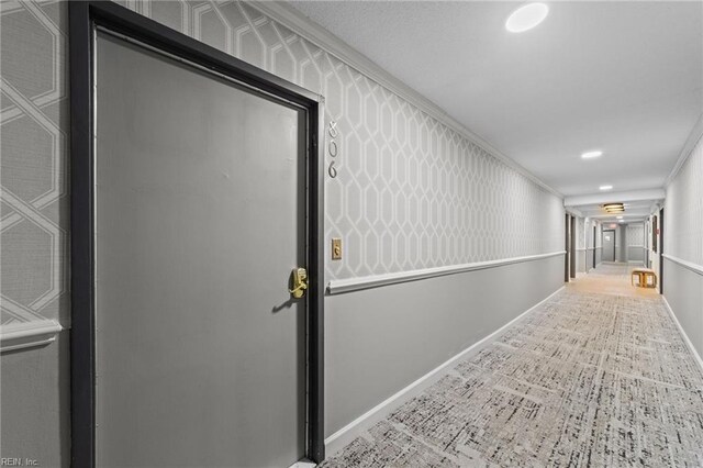 corridor with tile patterned floors and ornamental molding