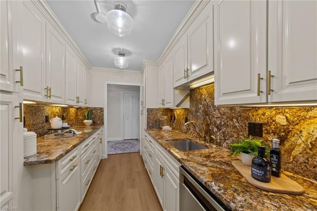 kitchen with white cabinets, tasteful backsplash, and sink