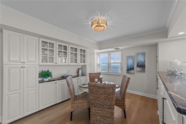 dining room featuring ornamental molding and hardwood / wood-style floors