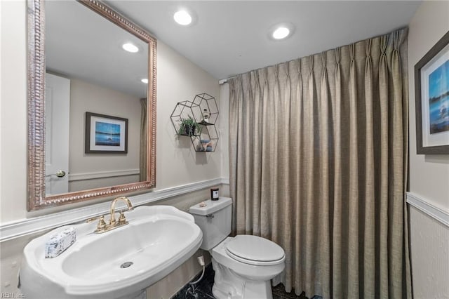 bathroom featuring toilet and sink