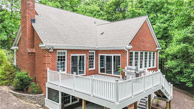 back of property featuring a wooden deck