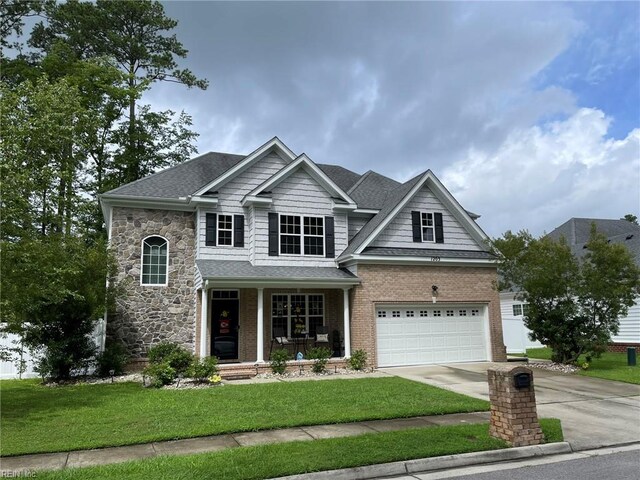 craftsman-style house with a garage and a front lawn