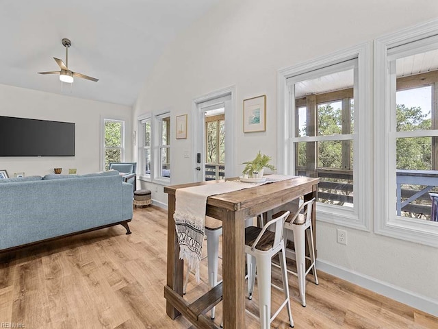 dining space featuring vaulted ceiling, ceiling fan, plenty of natural light, and light hardwood / wood-style floors