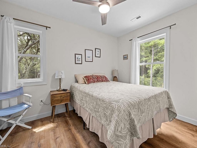 bedroom with ceiling fan and wood-type flooring