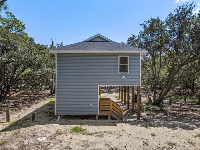 rear view of house featuring a carport and central air condition unit