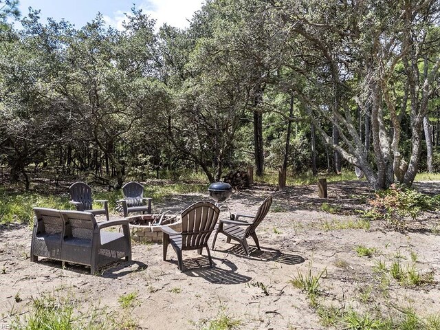 exterior space with a wooden deck and a fire pit