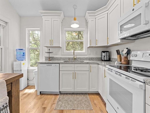 kitchen with white cabinetry, sink, white appliances, and pendant lighting