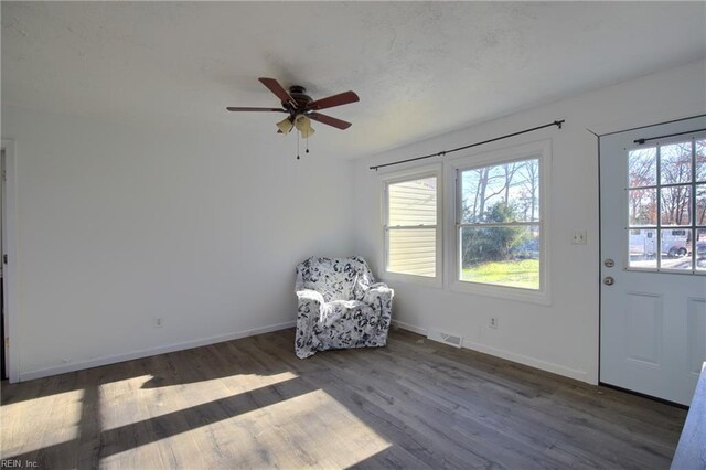 unfurnished room with ceiling fan and dark hardwood / wood-style flooring