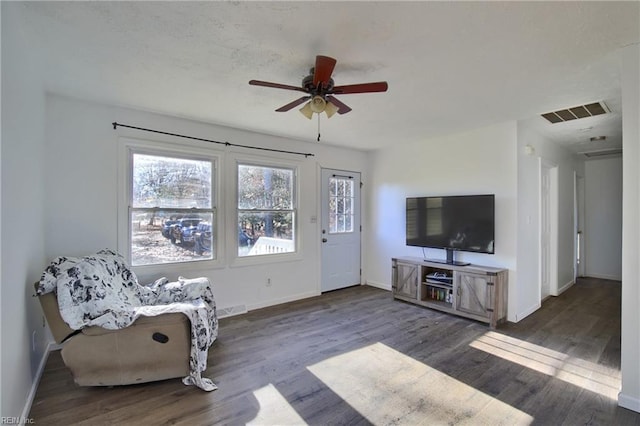 unfurnished room with ceiling fan and dark wood-type flooring