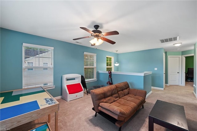 living room with light carpet and ceiling fan