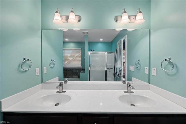 bathroom featuring double sink vanity and walk in shower