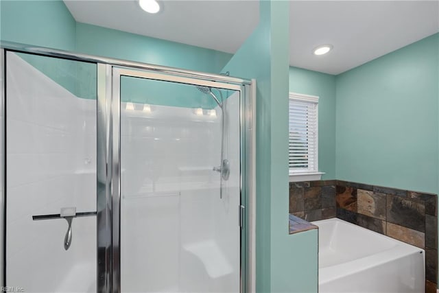 bathroom with separate shower and tub