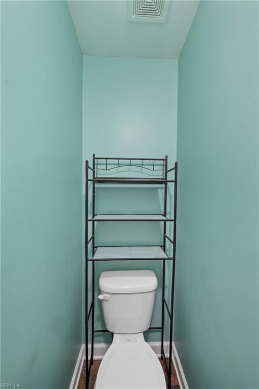 bathroom featuring hardwood / wood-style flooring and toilet