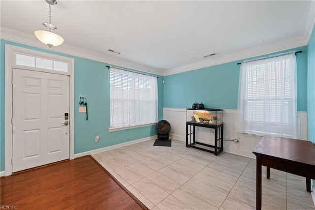 foyer entrance featuring light hardwood / wood-style flooring and ornamental molding