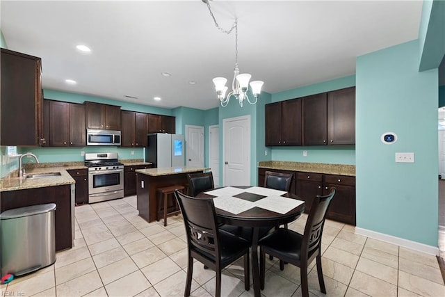 tiled dining space featuring sink and a chandelier