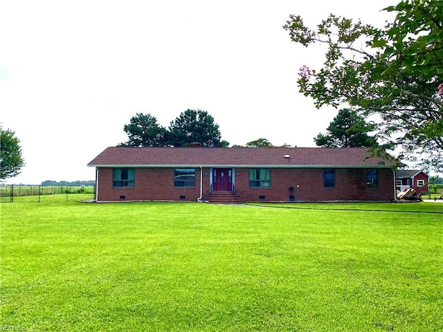 rear view of property with a lawn