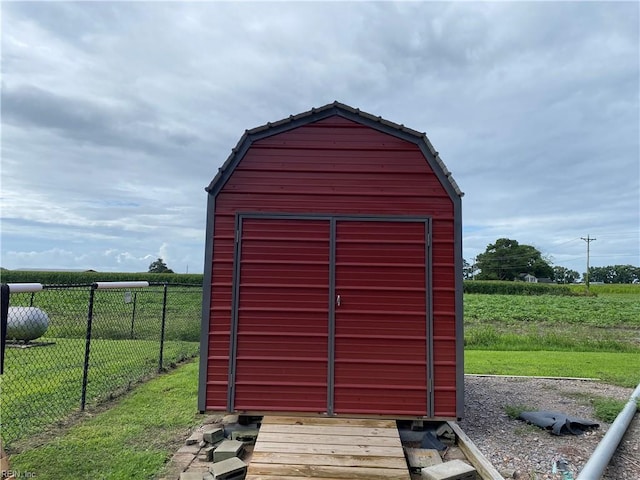 view of outdoor structure with a yard and a rural view