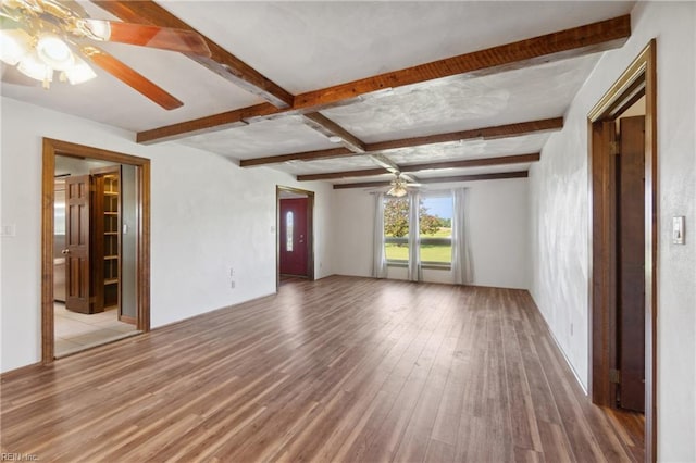 unfurnished room with light hardwood / wood-style flooring, ceiling fan, and beamed ceiling