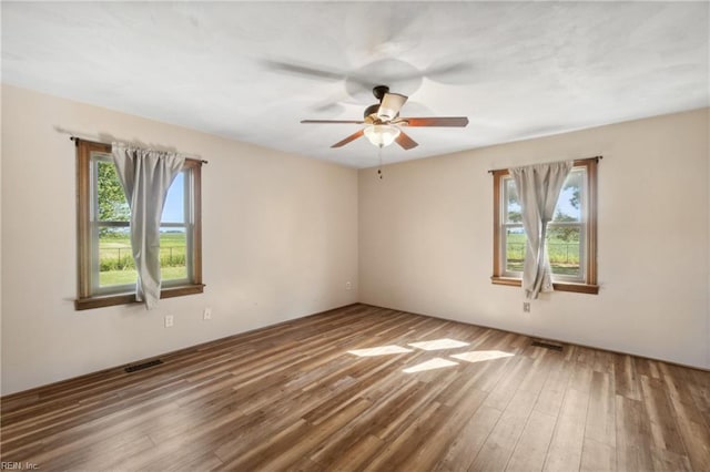 spare room with ceiling fan and hardwood / wood-style floors