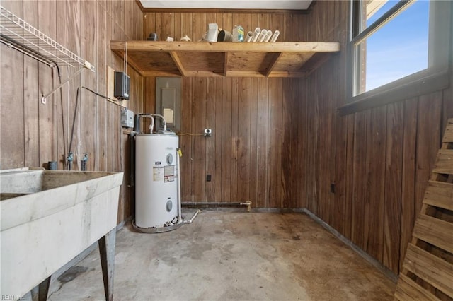 basement with wood walls and water heater