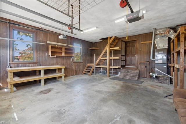 garage featuring a garage door opener and wooden walls